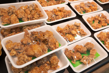 Japanese karaage fried chicken is sold in a styrofoam container at a grocery store. 