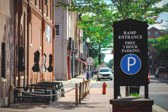 Anoka, MN, USA - Sept 10, 2025: A street scene with a sign for a parking ramp entrance with a cityscape in the background.  Editorial Use Only.