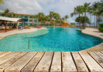 Wooden table top on the beach or sea. swimming pool Party on the beach  sunshine time concept.For montage product display or design key visual layout.View of copy space.