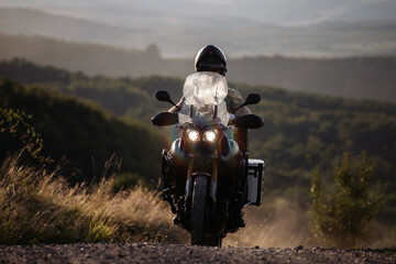 Man on his motorbike riding at sunset