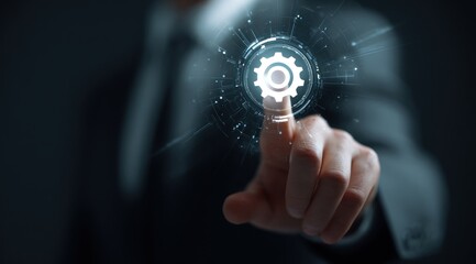 Fototapeta premium A man in a suit presses a glowing gear icon on a dark background, signifying technology, automation, and innovation in a corporate environment