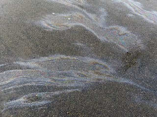 Closeup Stains of gasoline on asphalt