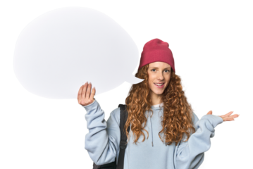 Redhead holding a comic speech bubble showing a copy space on a palm and holding another hand on waist.