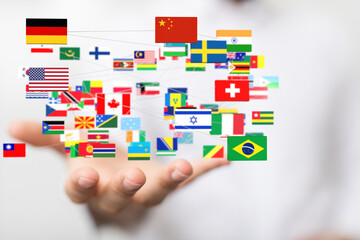 Hand holding interconnected flags representing global collaboration and international relations.