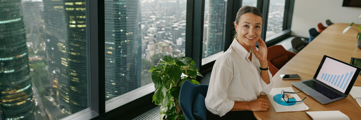 A Professional Woman is Engaged in her Modern Office, Focusing on Developing a Business Strategy