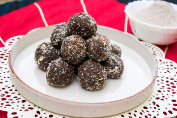 No sugar chocolate jaggery energy balls made with buckwheat flour. white coating of coconut.