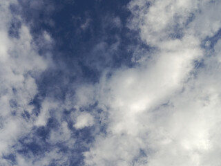 Dynamic Sky with Fluffy Clouds and Deep Blue Patches.