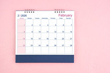 Directly above view of February 2026 desk calendar on pink background with copy space.