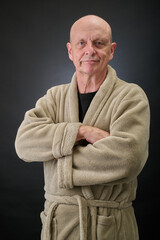 Closeup portrait of a serene aged and balded man in bathrobe