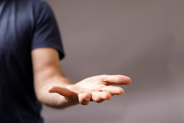 Close-up of a man's open hand, offering help, support, or receiving.  Perfect for concepts of giving, charity, and hope.