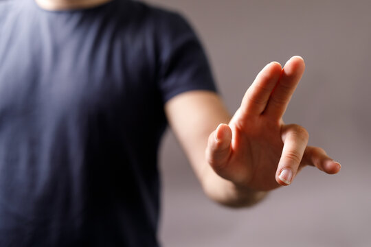Close-up image of a man's hand reaching out, perfect for concepts of interaction, technology, or connection. High-quality stock photo. - Powered by Adobe