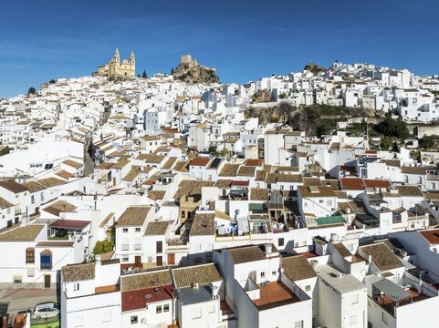 The hilltop White Town of Olvera with its La Encarnaci&oacute;n church and Moorish castle. Aerial view. Drone shot. C&aacute;diz province, Andalusia, Spain