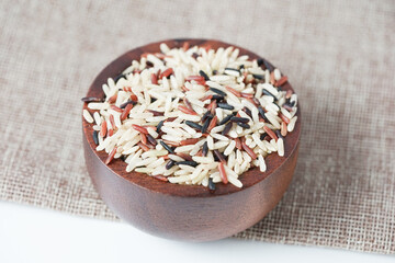 Close up of brown rice on a wooden bowl and copy space. Healthy food.
