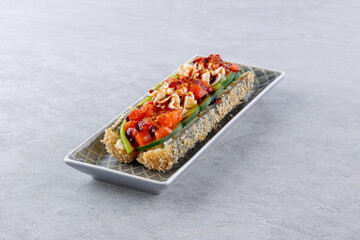 Crispy sushi roll with salmon, avocado, cream cheese and unagi sauce