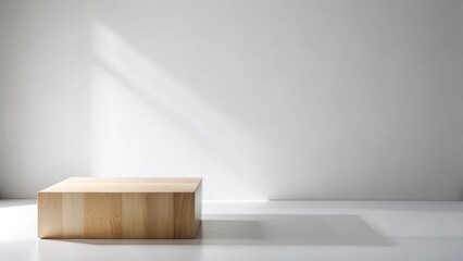 Fototapeta premium A simple wooden block sits on a pristine white surface, bathed in soft, natural light illuminating a minimalist interior scene