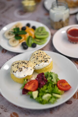 A colorful and appetizing breakfast setting, showcasing a variety of healthy food options on white plates, perfect for starting the day.
