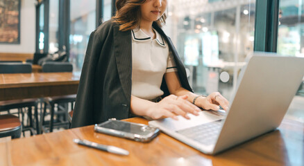 Business freelance young adult woman using laptop typing keyboard work with ai