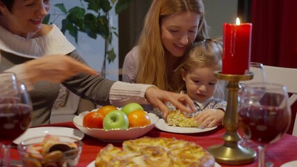 Freshly baked homemade pie served at festive family dinner with children and Christmas warm holiday lights. Cozy celebration and traditional holiday dessert.
