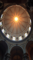 Obraz premium Sunlight Streaming Through Elegant Church Dome with Stained Glass Windows