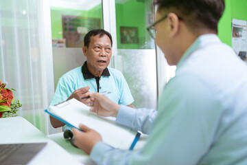 In a modern medical office, a skilled doctor consults a patient about their health and wellness