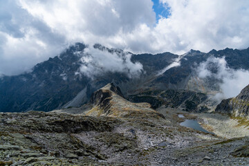 Ponds in the valley and over the ridge clouds billow, heralding the coming rain.
