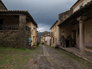 Cobblestone street winding through picturesque granadilla, spain, with traditional architecture