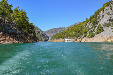 Türkiye, Side, August 22, 2025, tourist attraction green canyon, the white ship is sailing in the green canyon