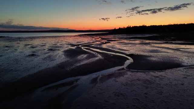 Drone footage of the mudflats on the coast of Ministers Island in New Brunswick, Canada at sunset