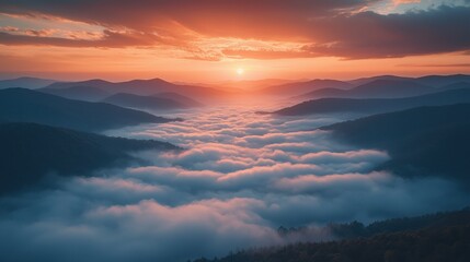 Beautiful sunrise over misty mountain range with vibrant orange and pink sky, rolling hills covered in fog, and a serene, peaceful landscape perfect for nature and travel themes