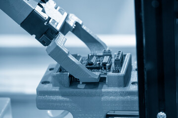 Close up scene the micro circuit board assembly process by robotic arm in the light blue scene.