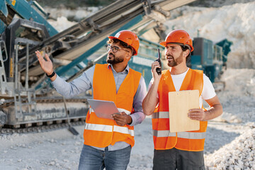 Engineers discussing and working together in a quarry