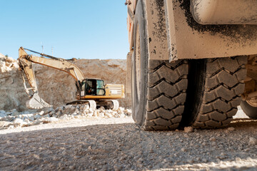 Dumper truck and excavator working in a quarry © Maria Vitkovska