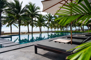 Relaxing poolside retreat with palm trees beachfront lifestyle photography sunny atmosphere relaxation concept