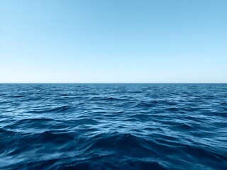 Obraz premium Calm blue ocean waves under a clear sky offer a serene and peaceful vista