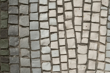 Smalt mosaic pattern with square tiles in gray and white shades.