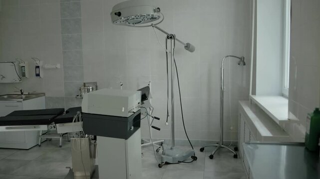 Surgical room in a clinic, interior. Couch and electrocoagulator in the room against the background of a window. Providing emergency health care, professionals