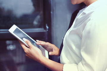 Business Woman Analyzing Financial Data on Tablet. Investment Analysis and Planning