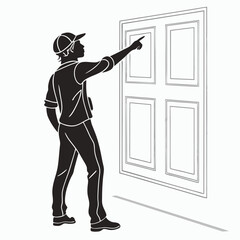 Man in silhouette wearing a cap pointing to the wall with paneling