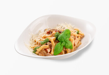 Traditional Italian casarecce pasta served with creamy mushroom sauce, grated parmesan cheese, pesto and fresh basil leaves in a white plate, classic homemade comfort food, isolated on white