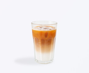 Layered iced latte with cold milk on the bottom and rich espresso on top, served in a clear glass with ice cubes for refreshing taste