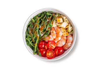 Delicious poke bowl with tender shrimp, fresh avocado cubes, cherry tomatoes, crisp greens and flavorful dressing, served in a paper bowl, top view