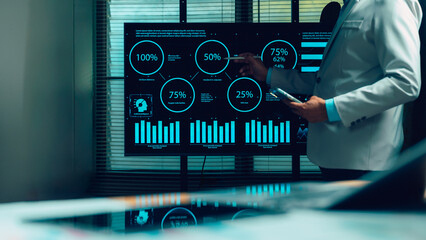 Business professional analyzes complex data visualizations, large digital screen. Expert employs stylus, reviewing AI insights, financial charts, performance metrics. Driving strategic decisions,