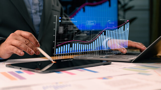 Businessman analyzing futuristic holographic chart showing financial growth. Professional using tablet stylus studies digital data visualization, market statistics, investment strategy. Corporate