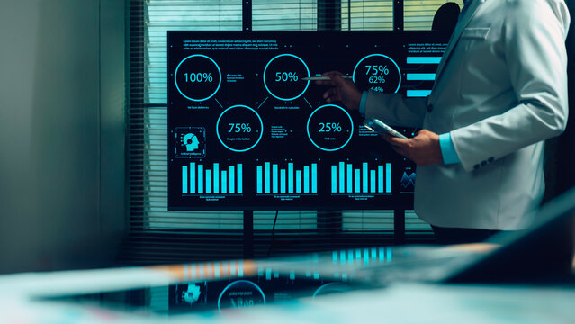 Business professional analyzes complex data visualizations, large digital screen. Expert employs stylus, reviewing AI insights, financial charts, performance metrics. Driving strategic decisions,