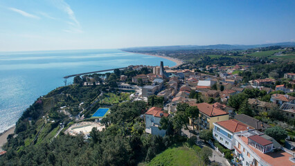 Majestic aerial panorama of Numana a charming coastal town in Le Marche Italy showcasing its historic buildings and picturesque seaside vistas under a clear blue sky