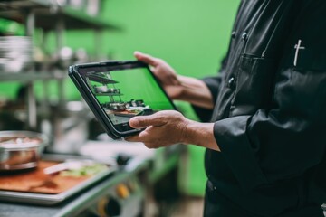 Chef views digital kitchen design on tablet