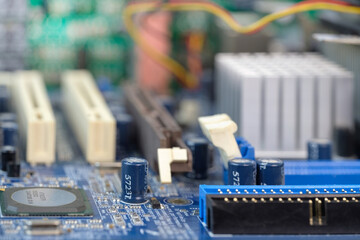A blue electronic circuit board background, close up