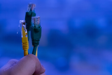 several rj 45 - wires for the Internet, on a blue background of the data center