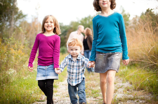 Happy Children Walking with Father and Mother in Nature
