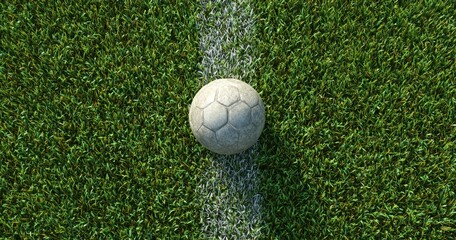 Obraz premium Top-down view of a textured soccer ball centered on a white sideline amidst verdant green grass